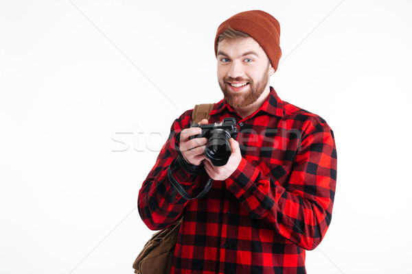 Handsome young man holding digital camera on white background Stock photo © deandrobot