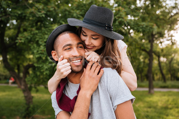 Smiling beautiful young couple having fun in park Stock photo © deandrobot