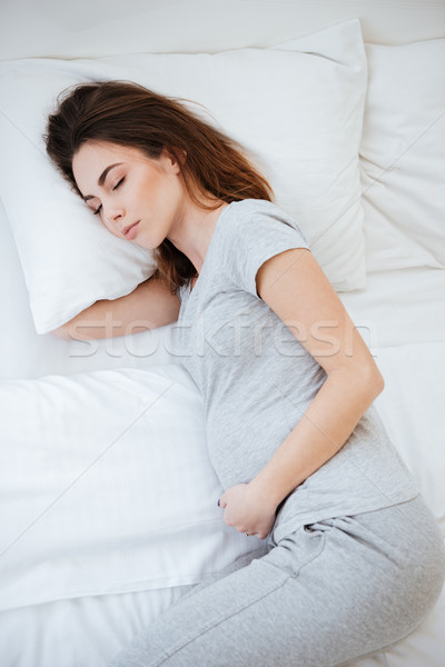 Vertical image of sleeping pregnant woman Stock photo © deandrobot