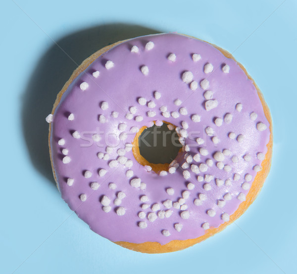 One colorful sweeties donut over blue background. Stock photo © deandrobot
