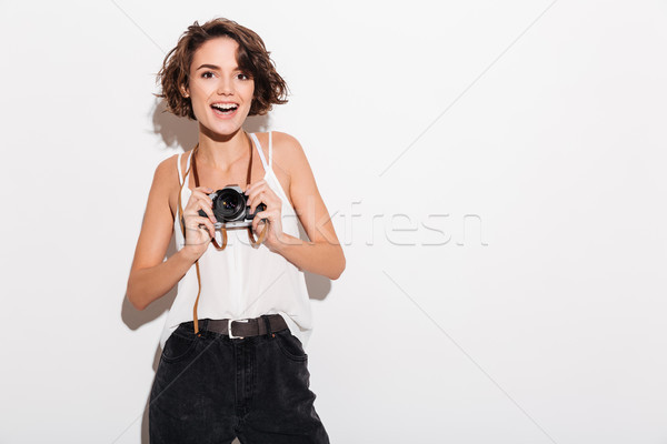 Izgatott nő fotós tart retro kamera Stock fotó © deandrobot