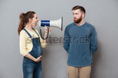 Shocked curly woman covering her ears while second girl screaming Stock photo © deandrobot