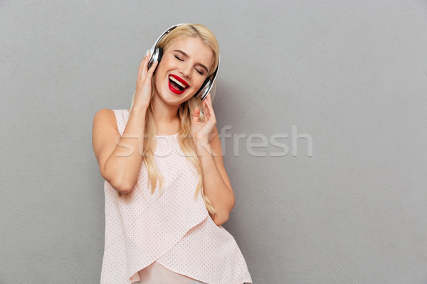 Stock photo: Portrait of a happy girl listening to music