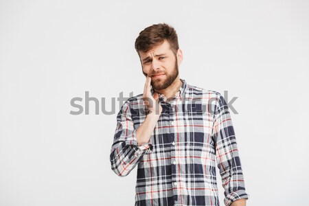 Portrait of a sad young man in plaid shirt Stock photo © deandrobot