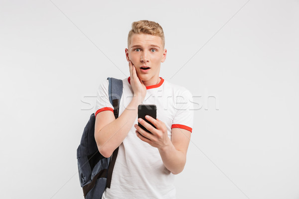 Image of surprised male student having clean healthy skin wearin Stock photo © deandrobot