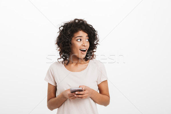 Tartalom barna hajú nő afro hajviselet okostelefon Stock fotó © deandrobot
