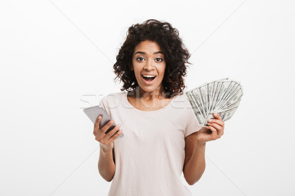 Happy winner american woman with afro hairstyle and big smile ho Stock photo © deandrobot