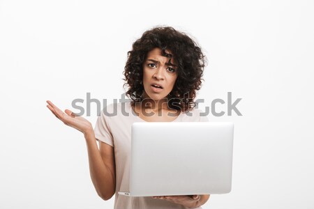 Portrait of confused young afro american woman Stock photo © deandrobot