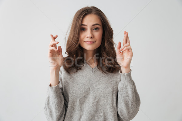 Zâmbitor bruneta femeie pulover rugăciune degete Imagine de stoc © deandrobot