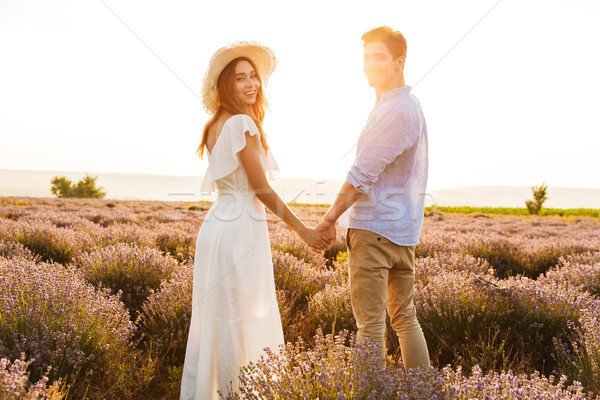 Cheery young couple embracing at the lavender field Stock photo © deandrobot