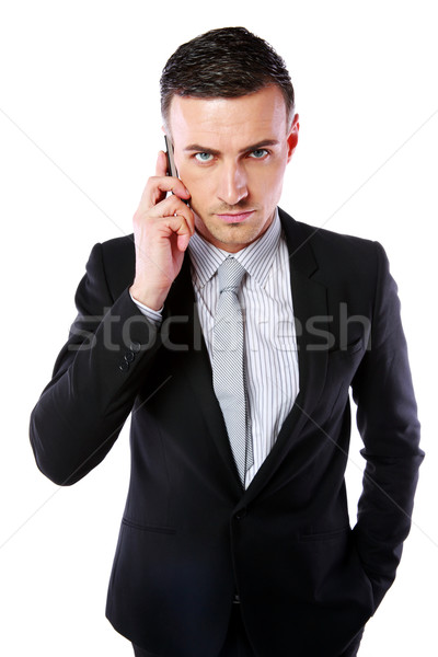 Business man talking on his mobile phone over white background Stock photo © deandrobot