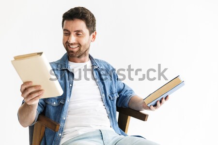 Male student sitting at the table and using laptop Stock photo © deandrobot