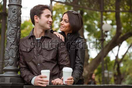 Couple standing with coffee outdoors Stock photo © deandrobot