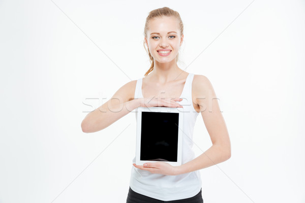 Glimlachend toevallig vrouw tonen scherm Stockfoto © deandrobot