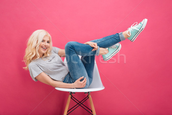 Woman sitting on the chair with raised legs Stock photo © deandrobot