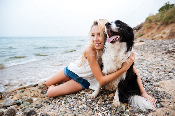 Gülümseyen kadın köpek plaj gülen Stok fotoğraf © deandrobot