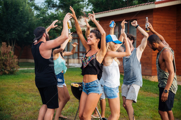 Young cheerful happy teens dancing at the picnic area Stock photo © deandrobot