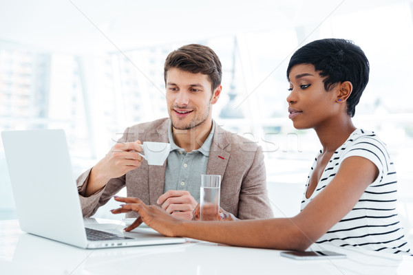 Stock photo: Multiethnic group of young business people having brainstorm in office