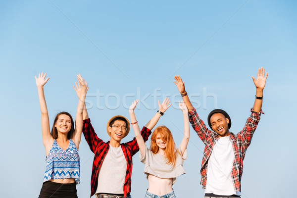 Grupo feliz jovem amigos em pé Foto stock © deandrobot