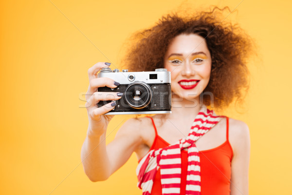 Smiling Bright model making photo on retro camera Stock photo © deandrobot