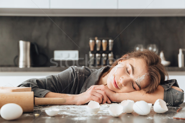 Lady sleeping in kitchen after cooking the dough. Stock photo © deandrobot