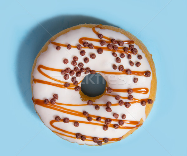 One colorful sweeties donut over blue background. Stock photo © deandrobot