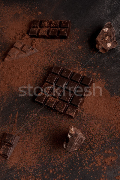 Dark chocolate bar covered in milk chocolate powder Stock photo © deandrobot