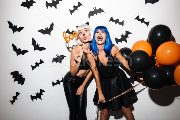 Young women in halloween costumes on party Stock photo © deandrobot