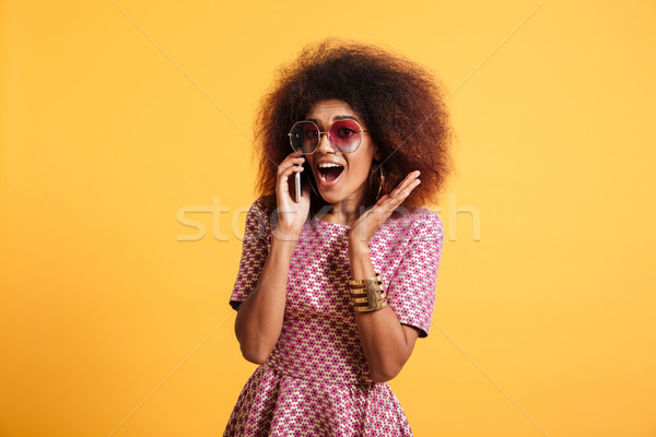 Portrait of an excited young afro american woman Stock photo © deandrobot