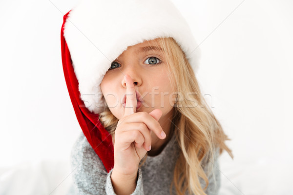 Close Up Portrait Of Pretty Little Girl In Santa S Hat Showing S