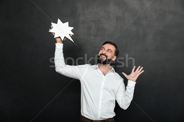 Photo of delighted man holding blank speech star and looking asi Stock photo © deandrobot