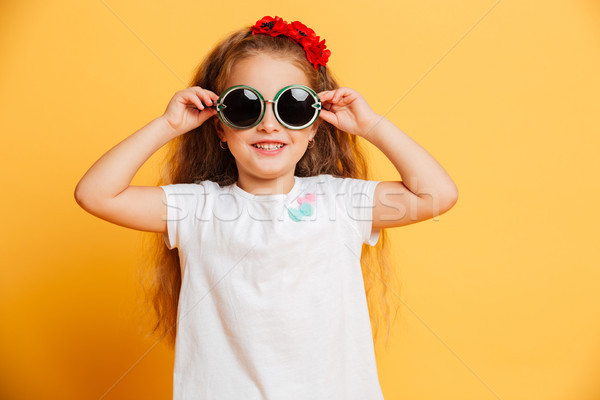 Little cute pretty girl standing isolated wearing sunglasses Stock photo © deandrobot