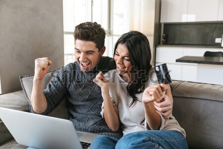Funny couple playing video games and looking camera Stock photo © deandrobot