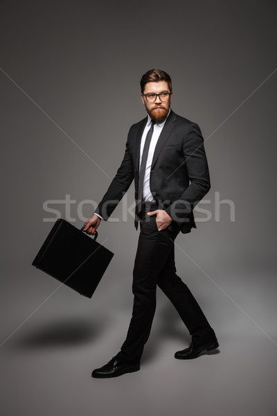 Full length portrait of a handsome young businessman Stock photo © deandrobot