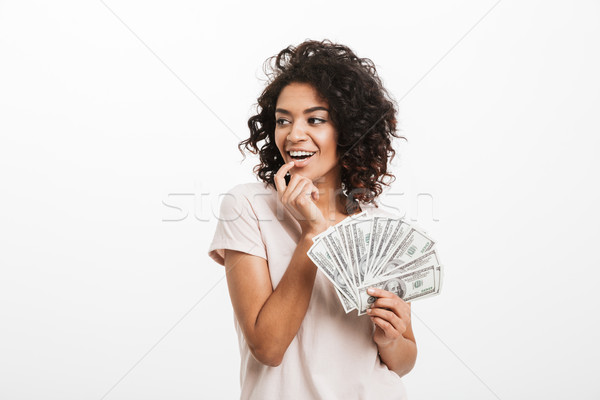 Joyous american woman with afro hairstyle and big smile holding  Stock photo © deandrobot