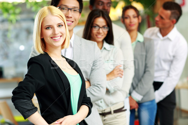 Happy group of business people in the office lined up Stock photo © deandrobot