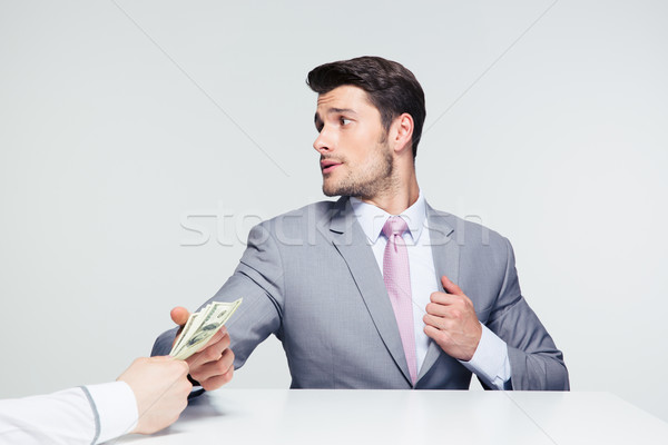 Businessman taking bribe Stock photo © deandrobot