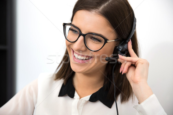 Cheerful female support operator in headset Stock photo © deandrobot