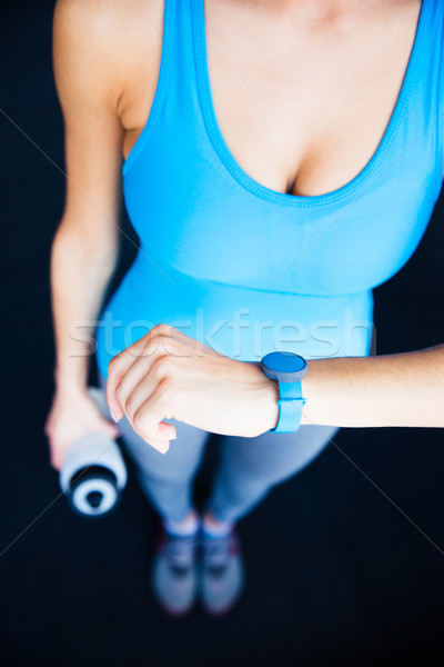 Closeup image of a woman with activity tracker Stock photo © deandrobot