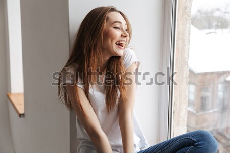 Tender attractive young woman posing near the curtains Stock photo © deandrobot