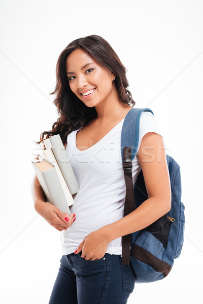 Smiling young asian student girl standing with books and backpack Stock photo © deandrobot