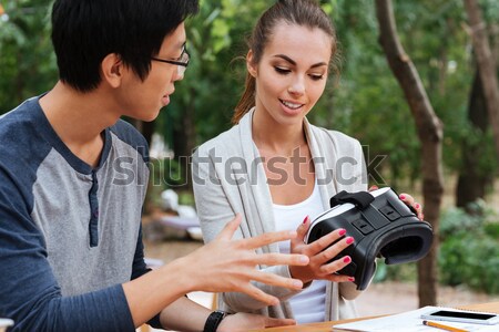 Couple holding and discussing virtual reality glasses outdoors Stock photo © deandrobot