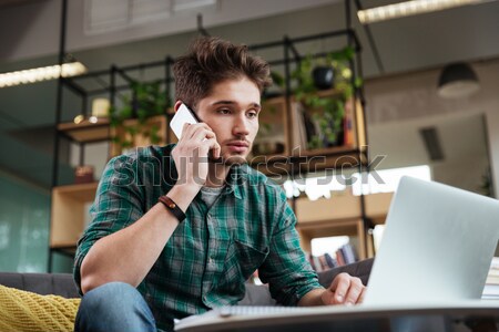 Fatigué homme canapé vert shirt séance [[stock_photo]] © deandrobot