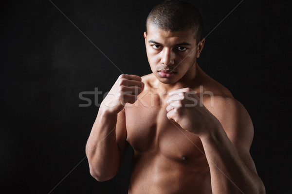Jóképű fiatal afrikai férfi boxoló pózol Stock fotó © deandrobot