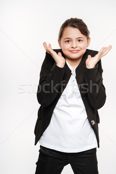 Confused young girl standing and posing Stock photo © deandrobot