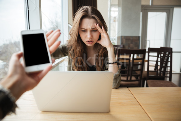 Stock photo: Woman with laptop and phone
