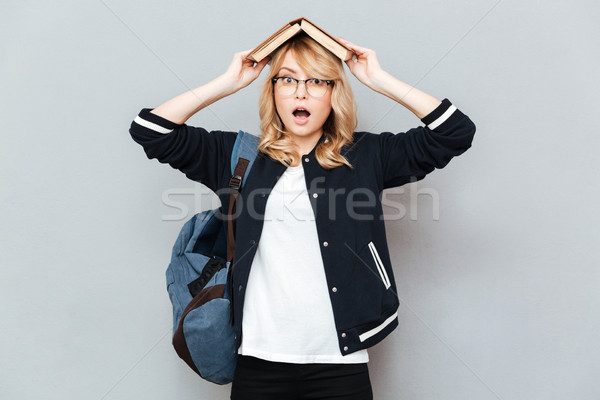 Student with book on head Stock photo © deandrobot