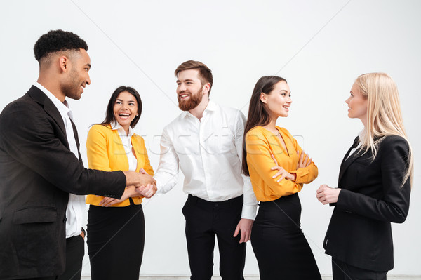 Happy colleagues business team standing in office Stock photo © deandrobot