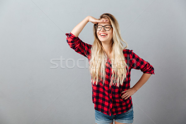 Emotional young blonde woman looking aside. Stock photo © deandrobot