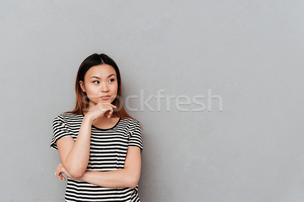 Stock photo: Thoughtful asian woman looking away